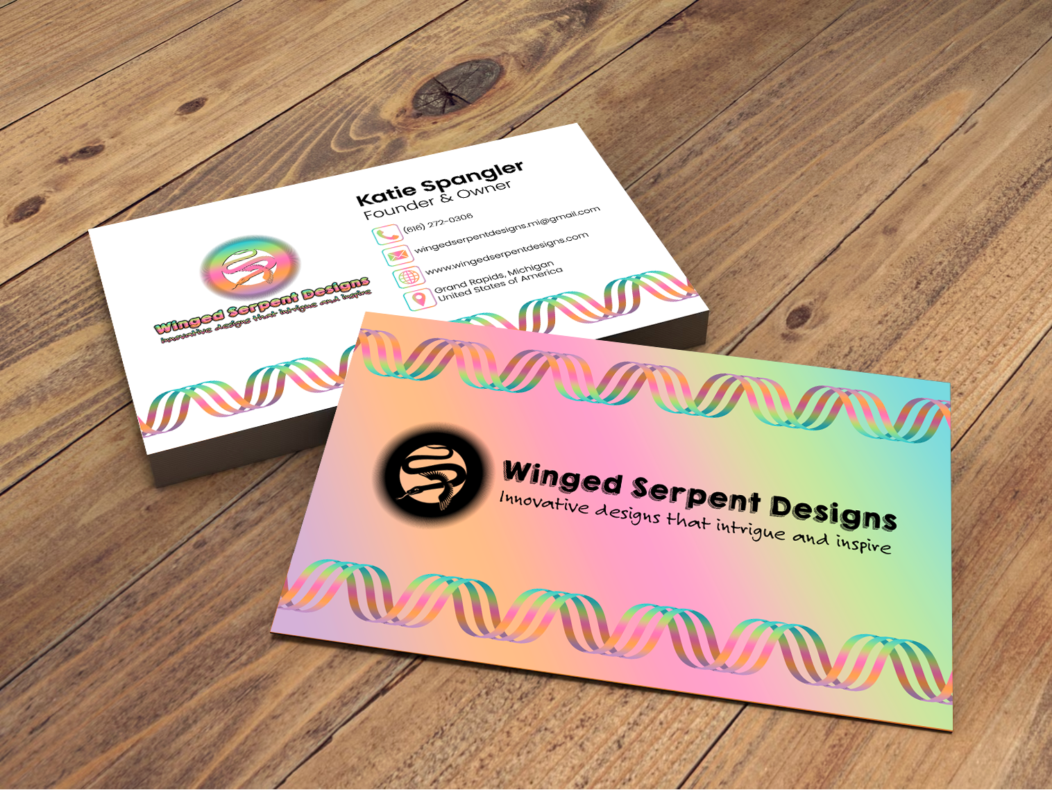A pile of colorful business cards with one flipped over to show the back